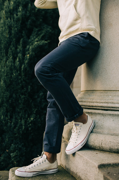 A pair of Foundation Pants folded on a black background.