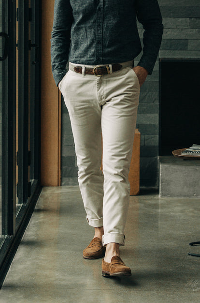 A pair of Foundation Pants folded on a black background.