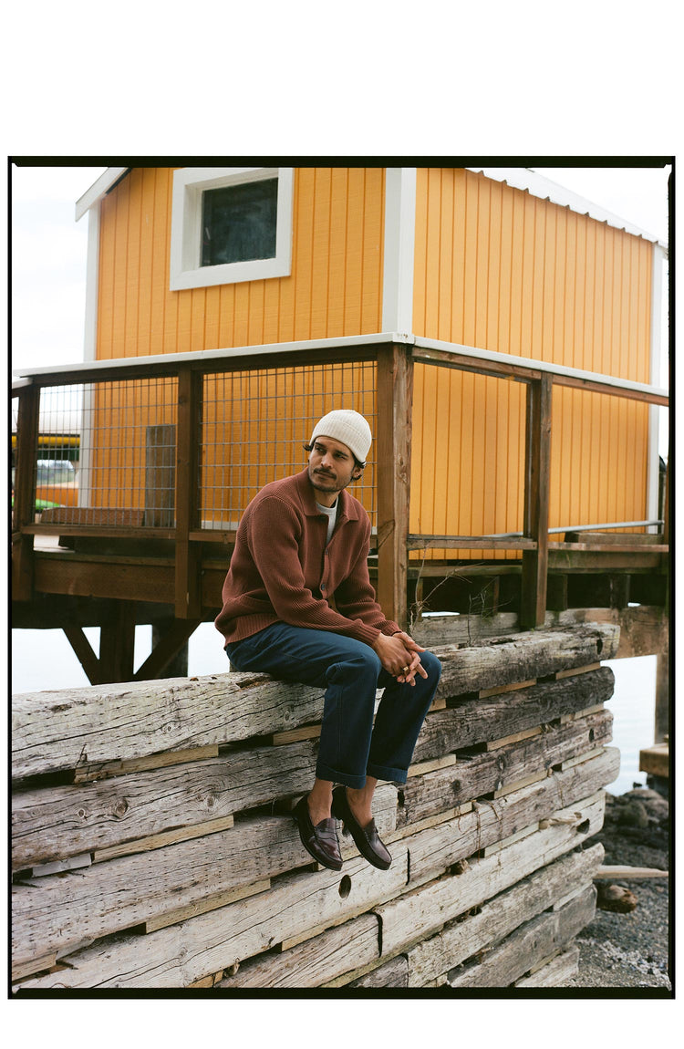 fit model sitting wearing The Harbor Sweater Jacket in Mahogany