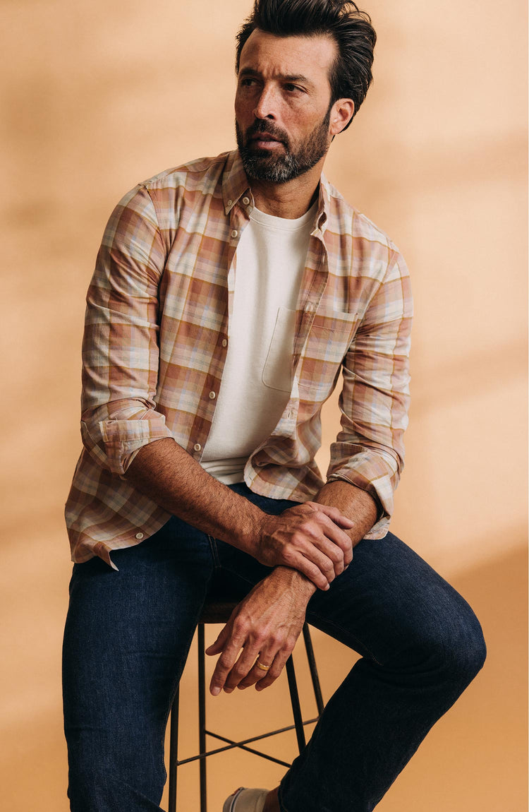 fit model sitting on a stool wearing The Jack in Baked Clay Plaid