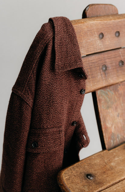 editorial image of The Ledge Shirt in Burgundy Linen Tweed on a chair