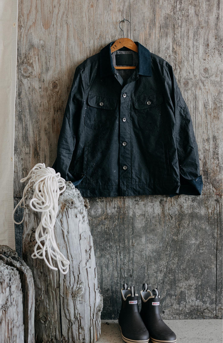 editorial mage of The Long Haul Jacket in Coal Waxed Canvas hanging