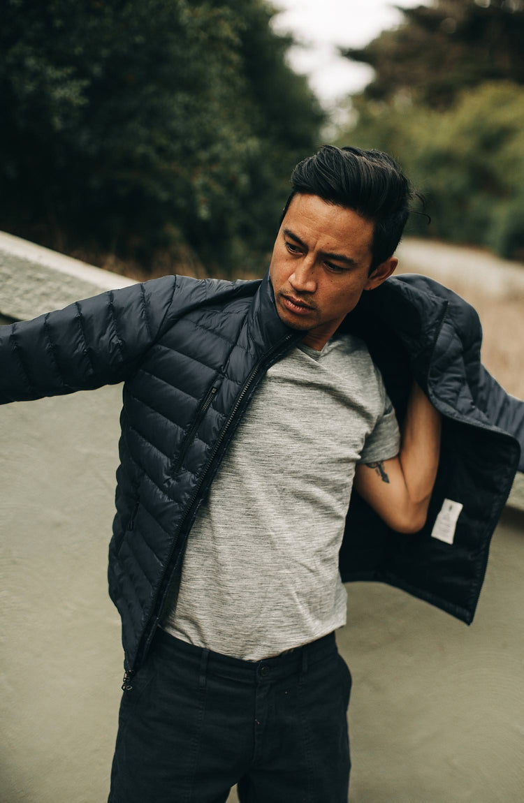 our guy rocking the merino tee near the park—with text overlaying