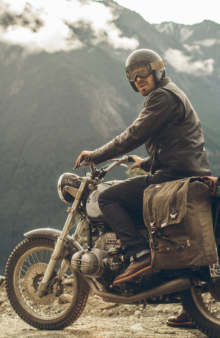 Motorcyclist riding with his leather jacket