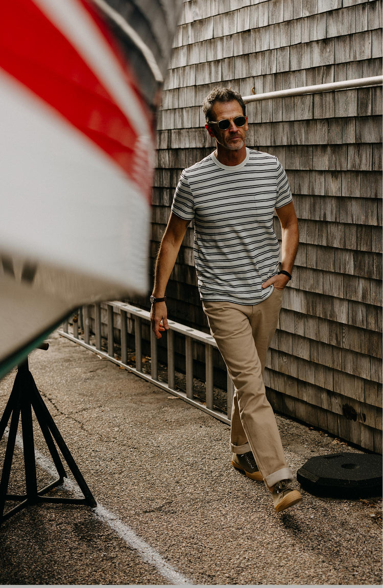 fit model walking wearing The Organic Cotton Tee in Washed Indigo Stripe