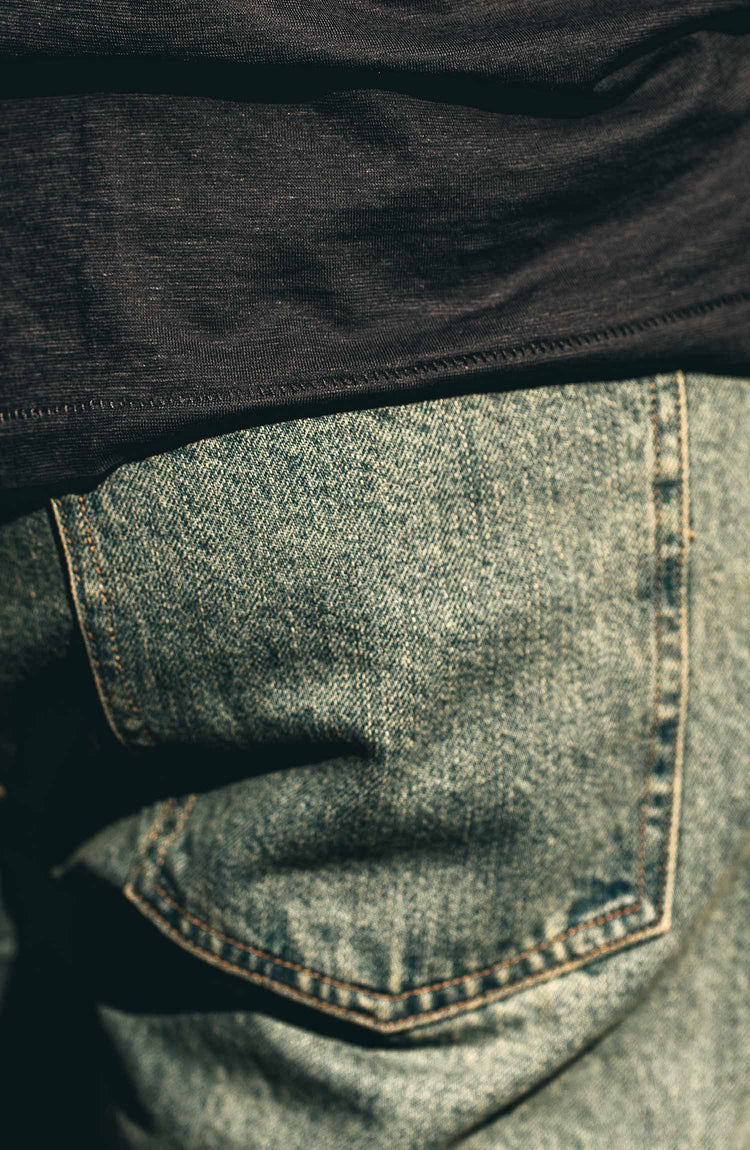 our fit model wearing the 24 month wash denim on the beach—pocket shot