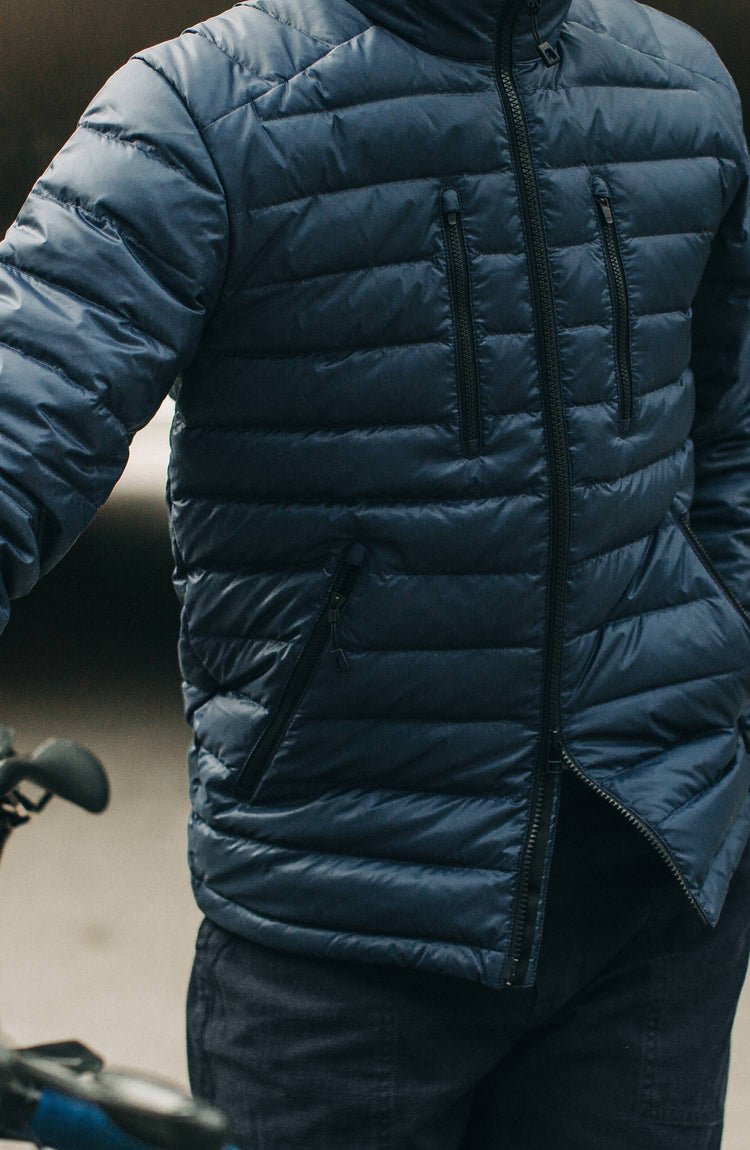 our model wearing the jacket next to his bike with text overlaying