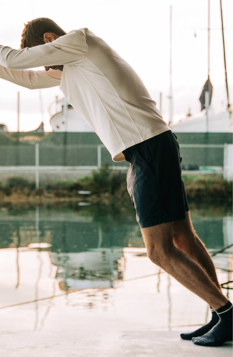 Our guy rocking The Tracksmith Collection long sleeve heavy bag, on a house boat