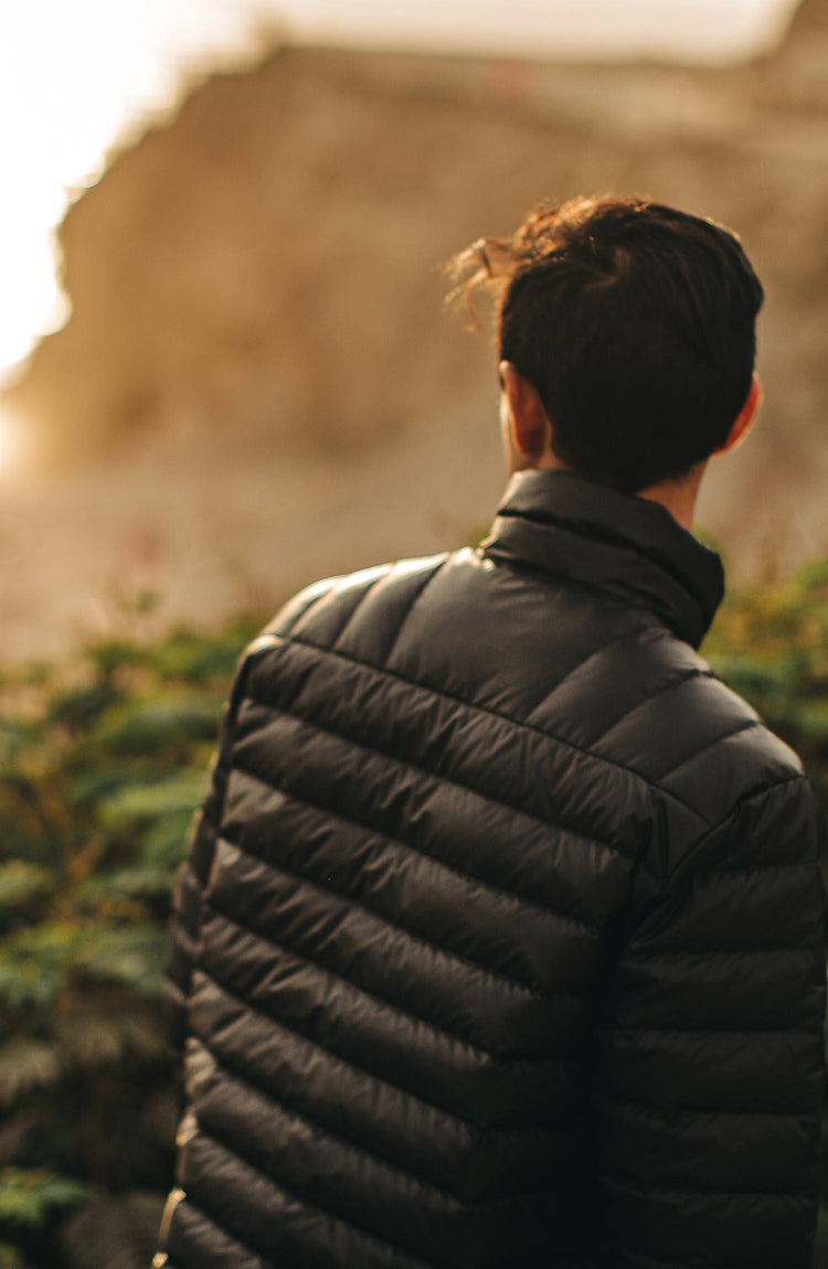 our model wearing the jacket near the coast with text overlaying