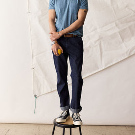 fit model standing on a stool in The Morse Pant in Rinsed Indigo Stripe, Bottoms by Taylor Stitch