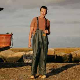 fit model holding a bucket of oysters in The Rugby Tee in Faded Brick, Knits by Taylor Stitch