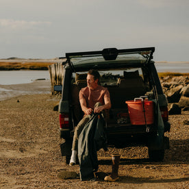 fit model sitting in a jeep in The Rugby Tee in Faded Brick, Knits by Taylor Stitch