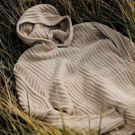 material shot of The Bryan Pullover Sweater in Flax Melange in the grass, Knits by Taylor Stitch