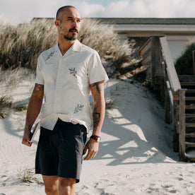 fit model walking on the beach wearing The Conrad Shirt in Seaside Embroidery, Wovens by Taylor Stitch