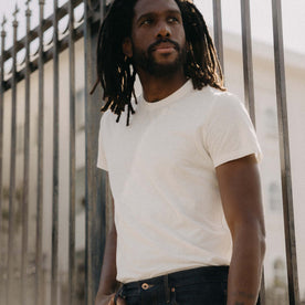 fit model leaning against the wall in The Cotton Hemp Tee in Natural, Knits by Taylor Stitch