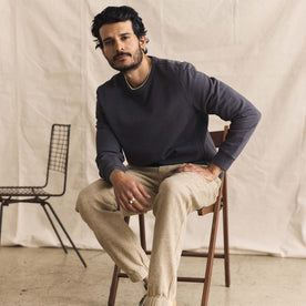 fit model sitting in The Cotton Hemp Crew in Asphalt, Knits by Taylor Stitch