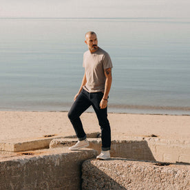 fit model standing on a rock wearing The Cotton Hemp Tee in Steeple Grey, Knits by Taylor Stitch