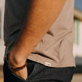 fit model showing off the logo on The Cotton Hemp Tee in Steeple Grey, Knits by Taylor Stitch