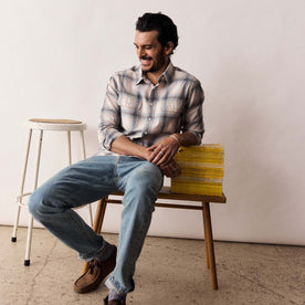 fit model sitting wearing The Craftsman Shirt in Sky Shadow Plaid, Wovens by Taylor Stitch