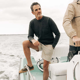 fit model on a boat in The Crawford Crew Sweater in Washed Asphalt, Knits by Taylor Stitch