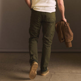 fit model showing off the back of The Democratic Jean in Olive Nihon Menpu Selvage, Bottoms by Taylor Stitch