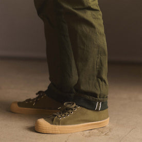 fit model showing off selvage cuffs on The Democratic Jean in Olive Nihon Menpu Selvage, Bottoms by Taylor Stitch