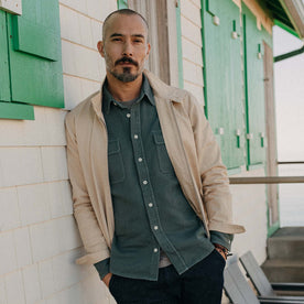 fit model leaning against the wall wearing The Flint Jacket in Light Khaki Broken Twill, Outerwear by Taylor Stitch