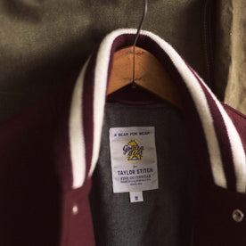 material shot of the tag on The Golden Bear Snap Bomber in Port Wool, Outerwear by Taylor Stitch