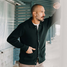 fit model with his hand in the front pockets of The Harbor Sweater Jacket in Black Pine Heather, Knits by Taylor Stitch