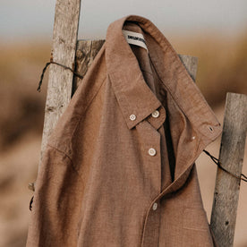 The Jack in Faded Brick Chambray hanging on a fence, Wovens by Taylor Stitch