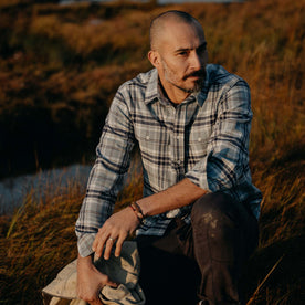 fit model sitting in The Ledge Shirt in Faded Blue Plaid, Wovens by Taylor Stitch