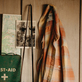 The Ledge Shirt in Sunrise Plaid hanging on a wall, Wovens by Taylor Stitch