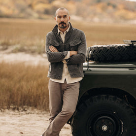 fit model leaning against a car wearing The Long Haul Jacket in Shale Cord, Outerwear by Taylor Stitch