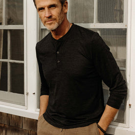 fit model posing in The Merino Henley in Heather Black, Knits by Taylor Stitch