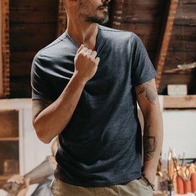 fit model adjusting the collar on The Merino Tee in Heather Navy, Knits by Taylor Stitch