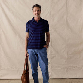 fit model posing with his hand in his pocket wearing The Organic Cotton Polo in Washed Indigo Stripe, Knits by Taylor Stitch