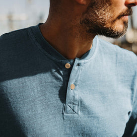 fit model showing off buttons on The Organic Cotton Henley in Washed Indigo, Knits by Taylor Stitch