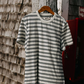 editorial image of The Organic Cotton Tee in Washed Indigo Stripe on a hanger, Knits by Taylor Stitch