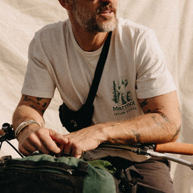 fit model sitting on a bike in The Organic Cotton Tee in Trail Buddies, Knits by Taylor Stitch