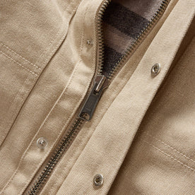 material shot of the YKK zipper on The Workhorse Utility Jacket in Light Khaki Chipped Canvas, Outerwear by Taylor Stitch