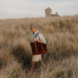 fit model walking carrying The Roughout Tote in Chocolate Suede, Accessories by Taylor Stitch