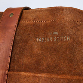 material shot of the branding on The Roughout Tote in Chocolate Suede, Accessories by Taylor Stitch