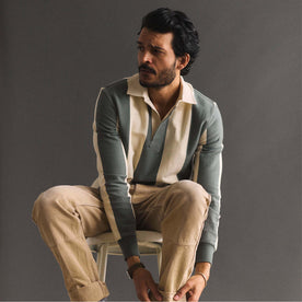 fit model adjusting his pant cuffs wearing The Rugby Shirt in Deep Sea Stripe, Knits by Taylor Stitch