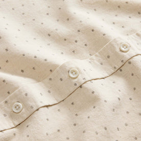 material shot of the natural buttons on The Short Sleeve Jack in Heather Oat Dot, Wovens by Taylor Stitch