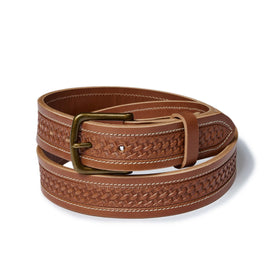 editorial image of The Tooled Belt in Saddle Tan rolled up, Accessories by Taylor Stitch