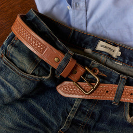 editorial image of The Tooled Belt in Saddle Tan on a pair of jeans, Accessories by Taylor Stitch