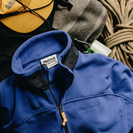 The Trail Fleece in Alpine Dusk next to a blanket and climbing rope, Outerwear by Taylor Stitch