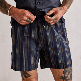 fit model tying the drawcords on The Apres Short in Indigo Stripe, Bottoms by Taylor Stitch