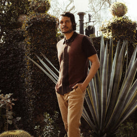 fit model in a garden in The Button Down Polo in Morita Seed Stitch, Knits by Taylor Stitch