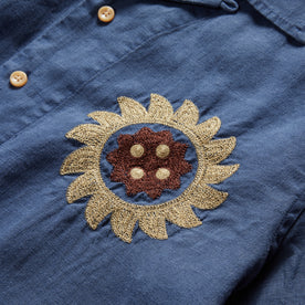 material shot of the sun embroidery on the left chest of The Embroidered Hawthorne in Sea Glass Hemp, Wovens by Taylor Stitch